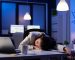 Entrepreneur working overtime on marketing project, falling asleep on desk while looking at financial documents trying to respect the deadline. Employee using modern technology network wireless